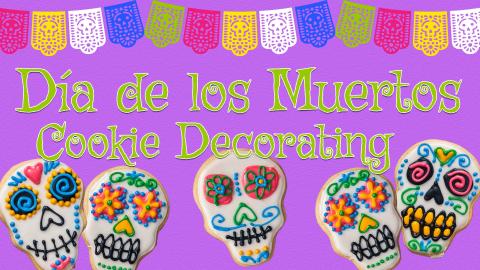 Image reads "Dia de los Muertos Cookie Decorating" against a purple textured background. To the left and right of the text are decorated sugar skull cookies. A colorful banner takes up the top portion of the image. 