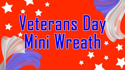 Image reads "Veterans Day Mini Wreath" against a red background. In the top left and bottom right corners are white stars. Two pieces of tulle are in the bottom left and top right corners.