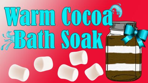 Image reads "Warm Cocoa Bath Soak" against a red background. Splashes of water are coming off some of the words. A jar filled with a layered cocoa bath soak is to the right of the title. Marshmallow are to the left of the jar and under the title. 