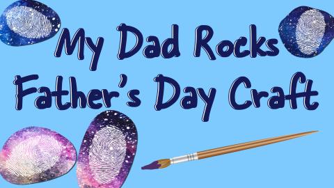 Image reads "My Dad Rocks Father's Day Craft" against a blue background. Rocks painted with a galaxy scene and a white thumb print in the center of the rock. A paint brush is under the title.