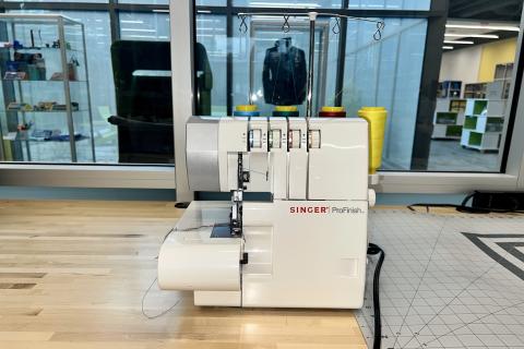 Image shows a Singer ProFinish serger machine.