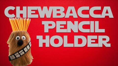 Image reads "Chewbacca Pencil Holder" against a red background. To the left of the title is a furry Chewbacca pencil holder with pencils in it.