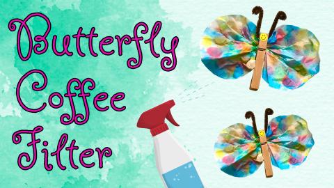Image reads "Butterfly Coffee Filter" against a green watercolor background. A spray bottle is spraying water at a watercolor coffee filter in the shape of a butterfly with pipe cleaner antennas.