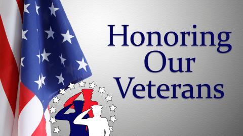 Image reads "Honoring Our Veterans" against a grey textured background. To the left of the title is an American flag and the silhouette of three soldiers saluting.