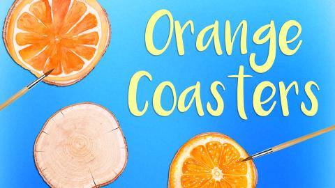 Image reads "Orange Coasters" against a blue gradient background. Under the title is a wooden disc painted to look like an orange, a plain wooden disc, and a paintbrush. To the left of the title is another wooden disc painted to look like an orange and a paintbrush.