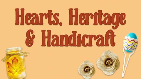 Image reads "Hearts, Heritage & Handicraft" against a textured background. To the bottom left of the title is a mason jar with fall leaves on it. To the bottom right of the title is a homemade maraca and two flowers made of book pages. 
