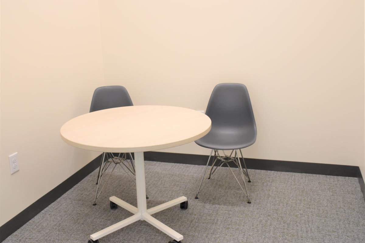 A table with two chairs. 