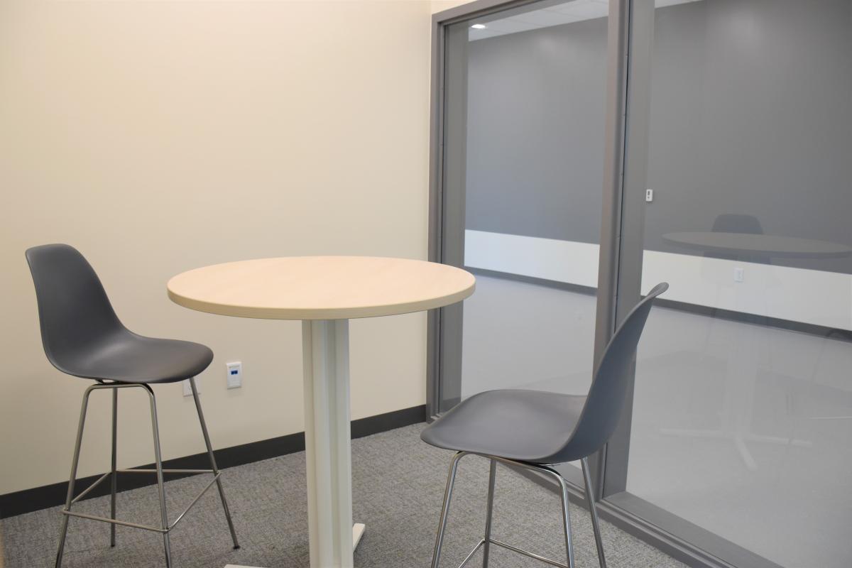 A high-top table with two chairs.