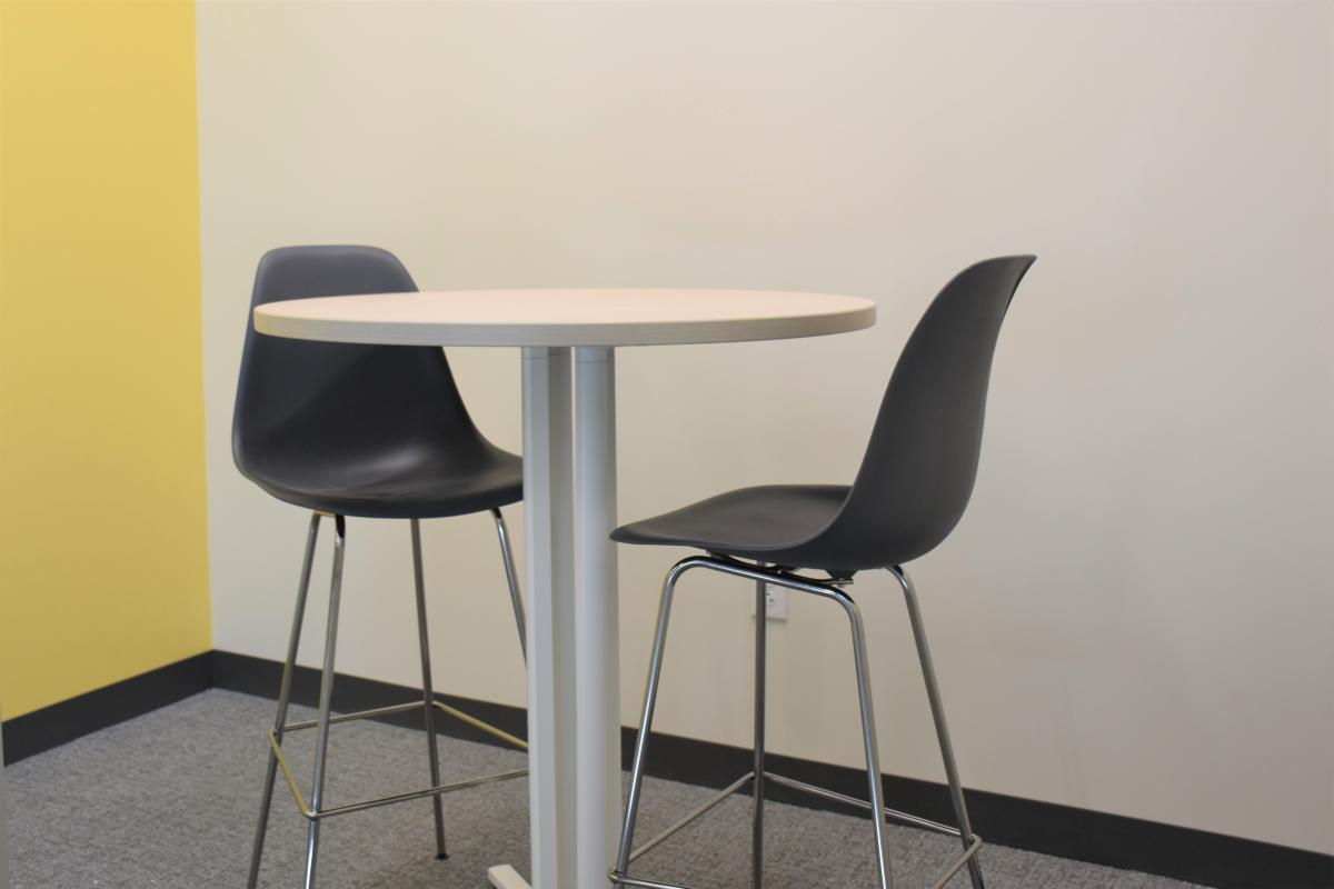 A high-top table with two chairs.